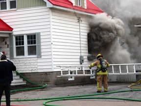 Heavy thick smoke pours from an Algonquin Avenue residence Wednesday morning.
PJ Wilson/The Nugget