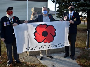 Devon Legion branch president Stanley Abma (right) and publicity chairman Brian Morris (left) present Mayor Ray Ralph with the first poppy of the 2020 campaign on Oct. 28.
(Emily Jansen)