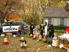 The Skeletons of Vivian Line and the Stratford police have teamed up to offer pandemic and general Halloween safety advice for those who plan to trick-or-treat or hand out candy Saturday night. Pictured, are Melissa McKerlie, the woman behind the October displays, and Stratford police Const. Darren Fischer standing among the safety conscious skeletons in Thursday's display. (Galen Simmons/The Beacon Herald)