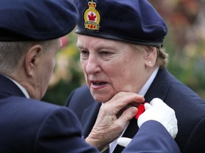 Pat Stewart, left, gives Marilyn Walsh a poppy before the start of Royal Canadian Branch 25's poppy campaign launch at the cenotaph on Queen Street East in Sault Ste. Marie, Ont., on Friday, Oct. 28, 2016. (BRIAN KELLY/THE SAULT STAR/POSTMEDIA NETWORK)