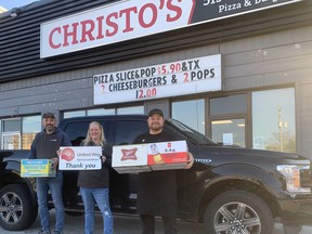 United Way of Sarnia-Lambton president Jason Killingsworth and On The Dot Delivery owner Paul Hartman and his wife Molly prepare a delivery truck with a United Way magnet sign for the first ever On The Dot Bottle Drive with Christo’s owner Chris Skillas. Anyone wishing to donate dottles can call 519-383-5566 to arrange pick up, or can drop off their bottles on Nov. 14, at the parking lot of Christos on the corner of Exmouth and Capel streets in Sarnia. United Way photo