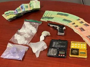 Chatham-Kent police supplied this photo of drugs, money and a weapon seized on Thursday that resulted in the arrest of a 32-year-old Chatham man.
