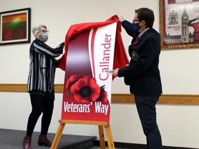 Lynne Lavigne and Callander Mayor Robb Noon unveil a banner for Veterans' Way in Callander, Friday. The section of Lansdowne Avenue from Pinewood Park Drive to Main Street will sport banners recognizing the sacrifices of those who have served.
PJ Wilson/The Nugget