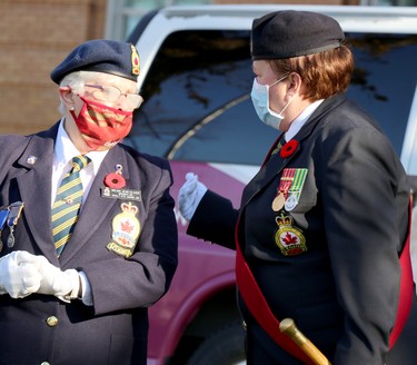 Wilma Oliver and Anneta Golder prepare for launch of Royal Canadian Legion Branch 25 poppy campaign at cenotaph on Queen Street East in Sault Ste. Marie, Ont., on Friday, Oct. 30, 2020. (BRIAN KELLY/THE SAULT STAR/POSTMEDIA NETWORK)