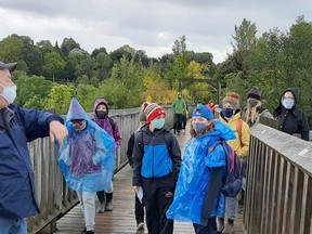 The Hensall Hikers Walk on the Wild side 4-H Club met for meetings five and six at the Menesetung Bridge trail in Goderich recently. At left, local historian David Yates spoke to the members about the history of the area. Handout