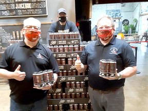 Br. 642 Royal Canadian Legion Pipe Band members Brent Flaglor (left) and Tom Elliott (right) are with Doug Hunter, a partner in Sons of Kent Brewery. They’re olding six-packs from the second batch of Fingask '45 red ale. The ale was made by the local brewery to help raise funds for the band, which has been idle during the COVID-19 pandemic. Handout