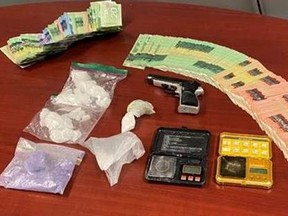 Chatham-Kent police supplied this photo of drugs, money and a weapon seized on Thursday that resulted in the arrest of a 32-year-old Chatham man. Handout