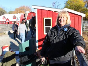 Donna Kelso, with the Seaway Kiwanis Club, stands in front of a freshly painted new gatehouse at the Children’s Animal Farm in Sarnia’s Canatara Park. Paul Morden/Postmedia Network