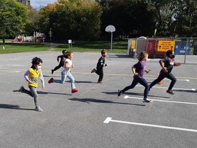 Children at Dr. F. J. McDonald Catholic Elementary School participate in a physically distanced Terry Fox run on Oct 1, 2020.