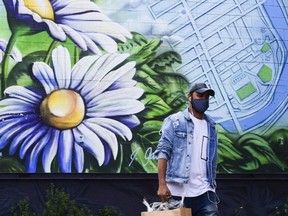 A man wears a mask as he shops in the Glebe community of Ottawa on Oct. 15, 2020.