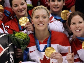 Meghan Agosta and her teammates on Canada's women's hockey team celebrate after receiving their gold medals at the 2010 Winter Olympics  at Canada Hockey Place on Feb. 25, 2010, in Vancouver, B.C.  (Photo by Bruce Bennett/Getty Images)