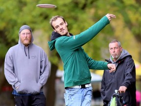 Ricky Friesen throws during a game with Brandon Rice, left, Bill Johnston and DJ Neufeld (not pictured) at the Thames Grove Disc Golf Course at the Thames Grove Conservation Area in Chatham, Ont., on Saturday, Oct. 24, 2020. (Mark Malone/Chatham Daily News)