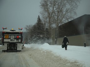 A snow plow heads past Keyano College and towards Franklin Avenue in downtown Fort McMurray, after a sudden snow storm hit Wood Buffalo on Wednesday, March 16, 2016. Olivia Condon/Fort McMurray Today/Postmedia Network