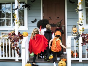 Young kids going trick-or-treating at Halloween.