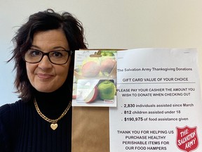 Alice Wannan, family services co-ordinator at the Owen Sound Salvation Army, holds up one of the brown paper "donation" bags that will be available at local grocery stores to encourage and remind people to donate gift cards for the food bank's Thanksgiving drive this year. SUPPLIED.