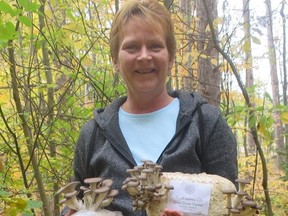 Joanne Anderson holds up a grey dove oyster mushroom growing kit that has begun to fruit at her home near Hanover. Anderson's home-based business Mushrooms Etc. has been operating for the past three months. SUPPLIED