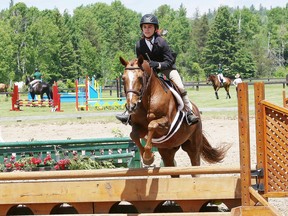 Julia Arnold takes part in a demonstration at the Foothills Farm open house and show jumping competition in Chelmsford, Ont. on Saturday June 11, 2016.