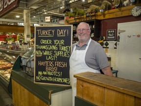 Bob McKeon is taking orders for turkeys at Chris's Country Cuts at Covent Garden Market. McKeon says Thanksgiving sales are slower than usual with most customers preferring smaller birds. (Derek Ruttan/The London Free Press)