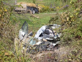 A woman was flown to hospital with critical injuries after the car she was driving left Mt. Carmel Drive, crashed into a grove and caught fire east of Grand Bend Road near Mt. Carmel Thursday, Oct. 1. (Derek Ruttan/The London Free Press)