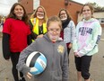 Keira Beattie is surrounded by smiling faces at St. George Catholic elementary school. Classmate Sophie Morgan, educational assistant Kelly Gagen, teacher Vanessa Vecchio and classmate Sydney Orange wear clear masks that allow Keira, who is deaf, to read lips. (Mike Hensen/The London Free Press)