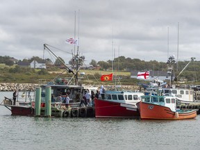 Members of the Sipekne'katik First Nation prepare to go fishing in Saulnierville, N.S., as it launches its own self-regulated "moderate livelihood" fishery on Sept. 17 -- a move that has been met with violent opposition by commercial lobster fishers. (Andrew Vaughan/The Canadian Press)