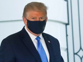 U.S. President Trump walks to the Marine One helicopter wearing a protective face mask as he departs the White House to fly to Walter Reed National Military Medical Center, where it was announced he will work for at least several days after testing positive for the coronavirus disease (COVID-19), on the South Lawn of the White House in Washington, U.S., October 2, 2020. REUTERS/Leah Millis/File Photo