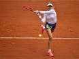 Westmount's Eugenie Bouchard returns the ball to Poland's Iga Swiatek during their third-round match at the French Open in Paris on Oct. 2, 2020.