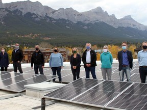 Officials, and elected officials, from the Town of Canmore, along with MLA for Banff/Kananaskis Miranda Rosin, stand on the roof of Elevation on October 8, to observe the new solar system now operational. The system is the largest in the Bow Valley, consisting of 931 panels and producing 372.4 kW of power recently finished installation. The system will offset approximately 24 percent of the power usage at Elevation Place. Photo Marie Conboy.