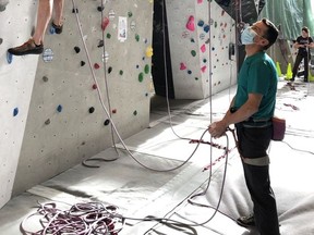 (Pictured) Pete Glanzig lead rock climbs, with Rob Price on belay, at Elevation Place Canmore on October 14. Face masks are required while not actively climbing and belaying. Currently only thirty people are allowed in the climbing gym at any one time. Access to Elevation Place amenities is permitted to individuals participating in a scheduled time slot for one activity only. Photo Marie Conboy/ Postmedia.