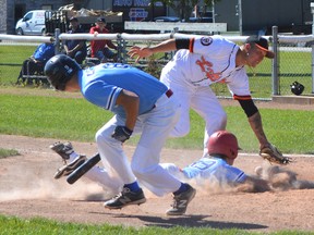 Jackson MacArthur of the Mitchell U21 Astros baseball team slides safely into home plate while Ryan Harmer scrambles out of the way during exhibition action against Lakeside at Mitchell's Cooper Standard diamond. HEATHER MONDEN