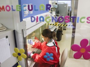 Medical laboratory technologist Danielle Lalonde works in the molecular diagnostics area of the medical microbiology laboratory in Belleville General Hospital. The lab now tests swabs from staff and doctors, in addition to patients, for COVID-19 to speed up delivery of results.