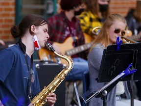 Ryan Pothier plays tenor saxophone while Solana McCaughen performs on trombone.