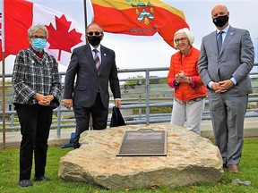 Former city councillor Kay Manderville, left, was thanked for her hard work serving five terms on council with the dedication Friday in her name of the pedestrian bridge over the Lott Dam. Manderville was joined in the unveiling by, from left, Coun. Garnet Thompson, Coun. Pat Culhane and Mayor Mitch Panciuk. CITY OF BELLEVILLE