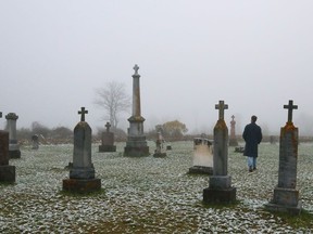 Tim Porter passes between gravestones dating back to the 19th Century at the graveyard across from St. Edmund's church near Stoco. He and his fellow members of Tweed and Company Theatre draw upon local settings for inspiration in their plays.