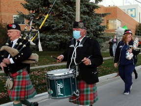 Newly-retired registered nurse Carol Armstrong, who was born in Scotland, smiles as she walks home from Trenton Memorial Hospital after her last shift Saturday. Piper Fred Alderman and drummer Patrick Hennessy provided some surprise musical accompaniment.