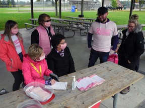 Karen Davis and Trisha Fess (seat at table), with Charlie Ellis, left and organizer Gail Catherwood behind, chat with Run for the Cure participants Josh Vanden Hengel and Kristy Hawley at Davis Park in Simcoe on Sunday morning. The annual event was  different because of COVID-19.