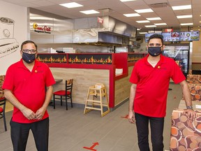 Sam's Grill owner Rajni Patel (left) stands inside his new Brantford location at 61 Lynden Road with his cousin Akash Patel, who will be the store manager.