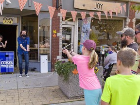 Morgan Fitzgerald and Janet Hartlen (right) watch as their daughter Mackenzie Fitzgerald, age 11 tosses an imaginary object to Port Dover-based illusionist Lucas Wilson.