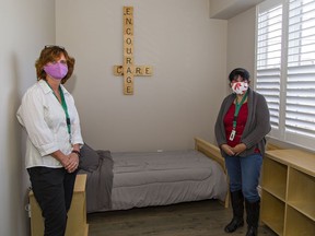 Brant County Safe Beds manager Kim Dillon (left) and team lead Maureen Acuna-Harrison show one of seven bedrooms at the new facility located at 84 Brant Ave. in Brantford.