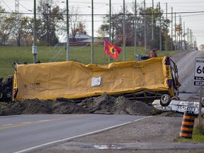 Protesters dug up the road on Argyle Street at the south end of Caledonia, Ontario, adding an overturned school bus and car to the barricade.