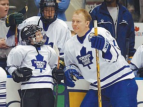 Toronto Maple Leafs centre Mats Sundin gets some tips from T.J. Brodie of Dresden, Ont., after the 11-year-old went 4-for-4 in the accuracy contest at the NHL team's skills competition in Toronto on Sunday, Jan.20, 2002. (CP PHOTO/Toronto Star/ Tony Bock)