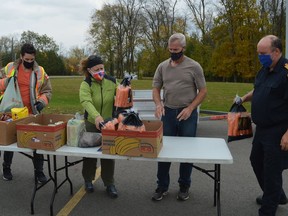 From left, Gavin Hamlin, Carol Ravnaas, Al Cyr and Rob Bowman pitch in at the Rotary Fall Food Drive drop-off location outside the Augusta township fire hall in Maitland on Saturday afternoon.
Tim Ruhnke/The Recorder and Times