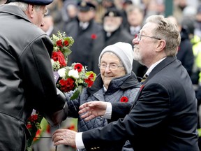 Edith MacFarlane presents a wreath on behalf of the Silver Cross Mothers, assisted by her son, Steven, during Brockville's Remembrance Day cermeony in 2019. (FILE PHOTO)