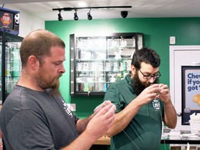 Higher Limits Cannabis Company owners Phil Bradbury, left, and Greg Kazarian hold up the "smell pods" at their Blenheim shop, which allow customers to see and smell dry cannabis flower before buying.