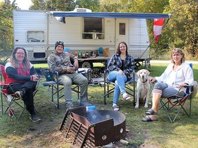 Tristen Stewart (left), Christian Bourbonnais, Bailey Stewart and mom Lisa Stewart, relax at their campsite on Saturday while spending Thanksgiving weekend at Rondeau Provincial Park. Ellwood Shreve/Postmedia Network