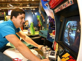 Zach Trinetti, owner of Barnetti's Arcade, plays one of the racing games at the Chatham business.