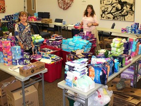 Marge Muharrem, left, staff support for Women United, and Patty Peters, resource director for the United Way of Chatham-Kent, were busy Wednesday sorting through the $16,000 worth of feminine hygiene products that were donated for Tampon Tuesday. (Ellwood Shreve/Chatham Daily News)