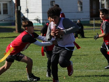 Ball carrier Alexander Moussa eludes defenders in a Cornwall Wildcats flag football peewee division game at Joe St. Denis Field. Photo on Sunday, October 12, 2020, in Cornwall, Ont. Todd Hambleton/Cornwall Standard-Freeholder/Postmedia Network
