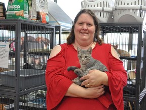Pawportunity Rescue founder Kathleen Dixon poses with one of the many cats up for adoption, on Sunday October 18, 2020 in Cornwall, Ont. Francis Racine/Cornwall Standard-Freeholder/Postmedia Network