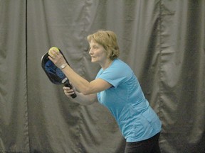 Francine Groulx, one of the founding organizers of a pickleball group in Cornwall, getting ready to serve during a match at the Benson Centre fieldhouse several winters ago. Photo in Cornwall, Ont. Todd Hambleton/Cornwall Standard-Freeholder/Postmedia Network